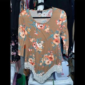 Quarter length sleeve with floral print and lace.